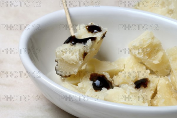 Parmesan cheese, pieces of cheese with crema di balsamico in small bowls