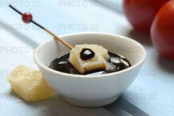 Parmesan cheese, pieces of cheese with crema di balsamico in small bowls