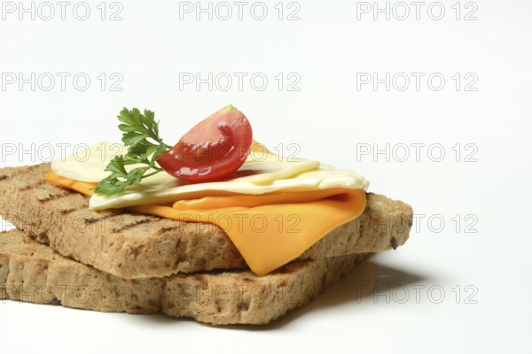 Processed cheese, slices of processed cheese on toast and tomato