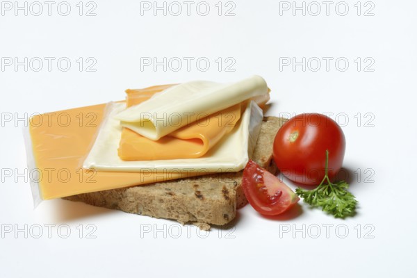 Processed cheese, slices of processed cheese on toast and tomato