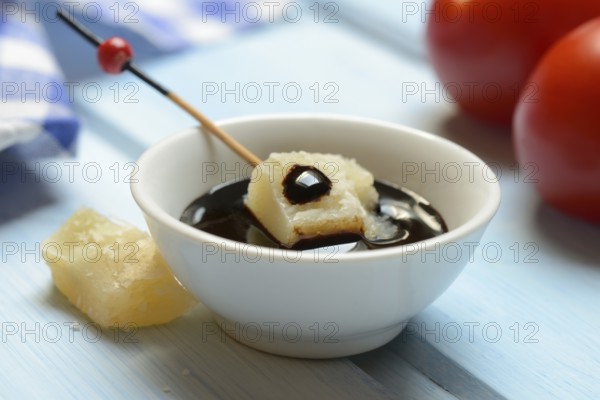 Parmesan cheese, pieces of cheese with crema di balsamico in small bowls