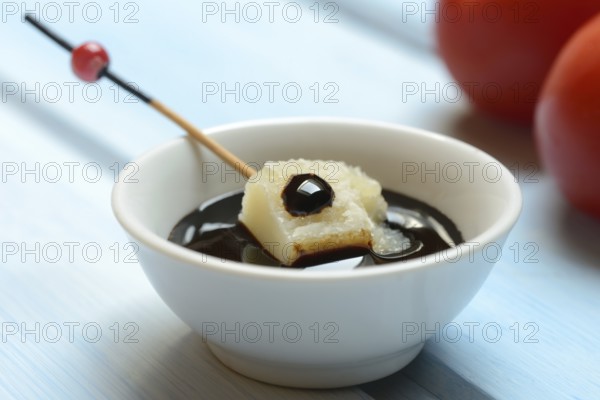Parmesan cheese, pieces of cheese with crema di balsamico in small bowls