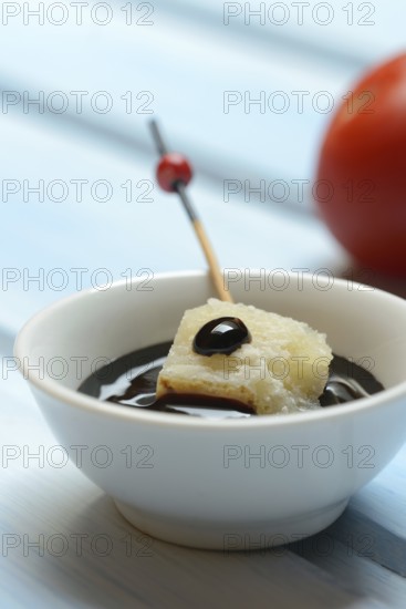 Parmesan cheese, pieces of cheese with crema di balsamico in small bowls