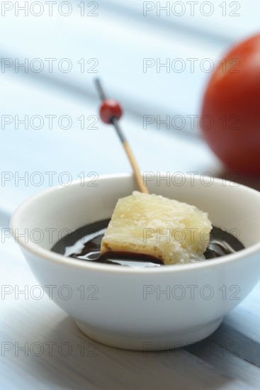Parmesan cheese, pieces of cheese with crema di balsamico in small bowls