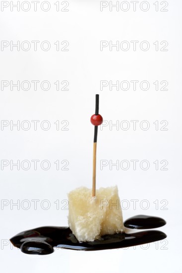 Parmesan cheese, piece of cheese with crema di balsamico
