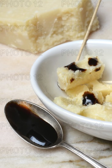 Parmesan cheese, pieces of cheese with crema di balsamico in small bowls