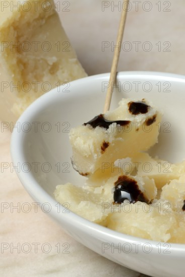 Parmesan cheese, pieces of cheese with crema di balsamico in small bowls