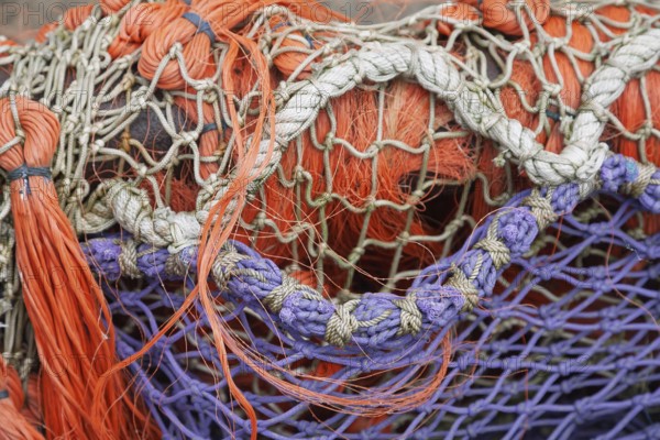 Close-up of superimposed, colourful fishing nets in orange and purple, East Frisia, Lower Saxony, Germany