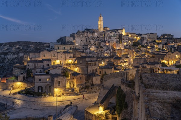 City view of Matera with the Sassi cave settlements and the cathedral at dusk, Matera, Basilicata, Italy