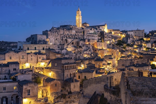 City view of Matera with the Sassi cave settlements and the cathedral at dusk, Matera, Basilicata, Italy