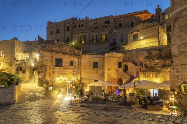 Restaurants in Sasso Barisano at dusk, Matera, Basilicata, Italy