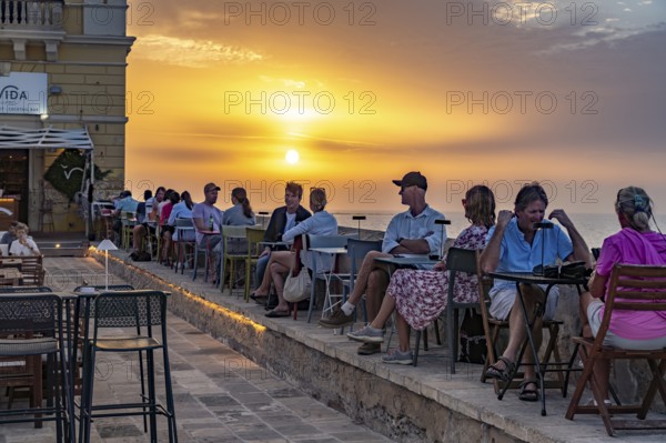 Restaurant by the water at sunset, Gallipoli, Apulia, Italy