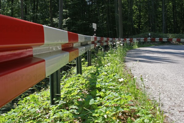 Crash barrier on the road, dangerous bend