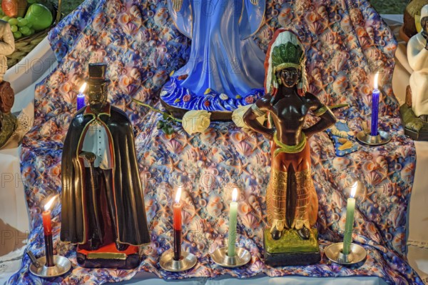 Umbanda altar with its deities and objects of worship lit by candles at night, Belo Horizonte, Minas Gerais, Brazil
