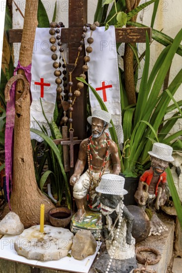 Divinities and objects from Umbanda and Cotolicism mixed on an altar among the plants, Belo Horizonte, Minas Gerais, Brazil
