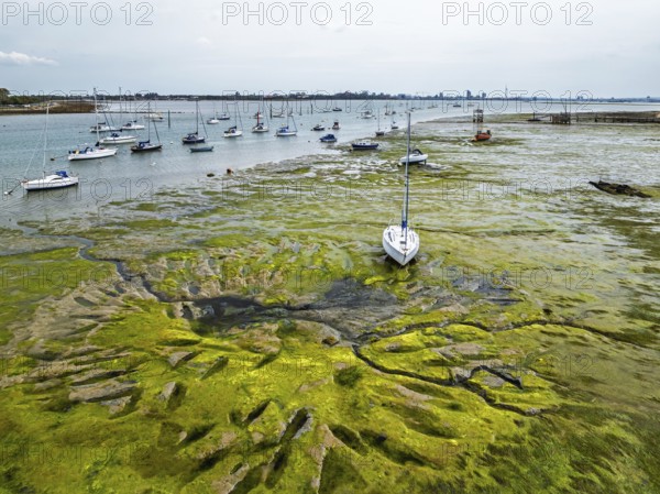 Boats and mud from drone, Paulsgrove Lake, Portchester Castle, Portchester, Fareham, Hampshire, England, United Kingdom