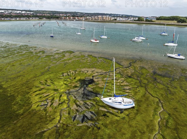 Boats and mud from drone, Paulsgrove Lake, Portchester Castle, Portchester, Fareham, Hampshire, England, United Kingdom