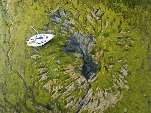 Top Down over boat and mud from drone, Paulsgrove Lake, Portchester Castle, Portchester, Fareham, Hampshire, EnglandDefault