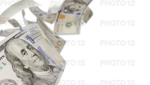 Randomly falling U.S. 100 dollar bills isolated on a white background