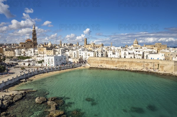 Old town of Monopoli with the cathedral, city walls and Cala Porta Vecchia beach seen from above, Apulia, Italy