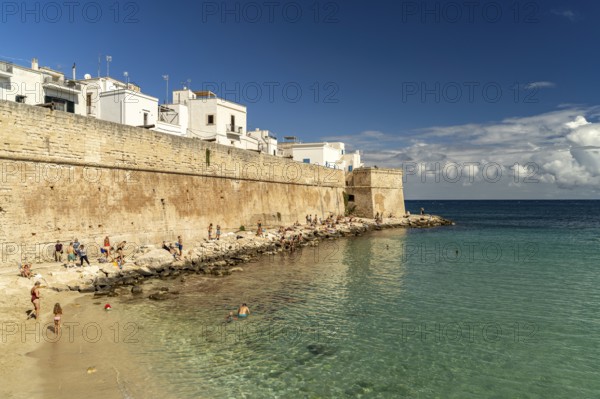 City wall and Cala Porta Vecchia beach in Monopoli, Apulia, Italy