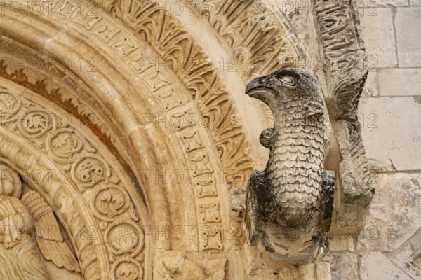 Bird's head above the portal of the church of Santa Maria Maggiore in Monte Sant'Angelo, Gargano, Apulia, Italy
