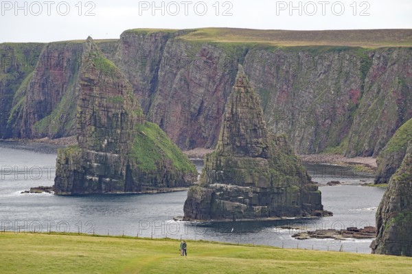 Majestic coastal cliffs surrounded by green grass and the sea, Duncansby Stacks, Thurso, Old Town, Calton Hill, Edinburgh, Scotland, United Kingdom