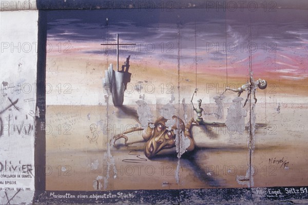 Painting, marionettes of a set piece by M. Engel, created in the 1990s at the Berlin Wall, Berlin, Germany