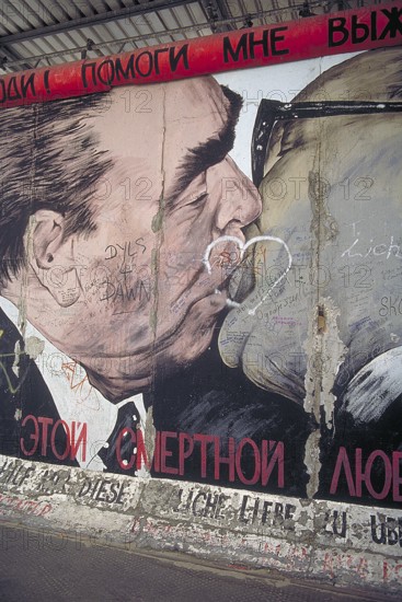 Artwork shows Leonid Brezhnev and Erich Honecker kissing, painting was created in 1990 at the Berlin Wall, Berlin, Germany