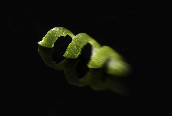 Lime zest in front of a black background, zoom effect