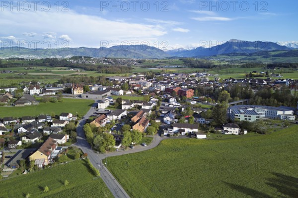 View of the village with the neighbourhood Oberdorf and the catholic parish church Mariä Geburt, in the background the Rigi, Sins, Freiamt, Canton, Aargau, Switzerland
