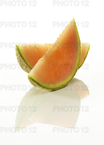 Cantaloupe melon, 2 melon slices against a white background