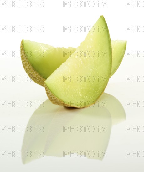 Honeydew melon, 2 melon slices in front of a white background