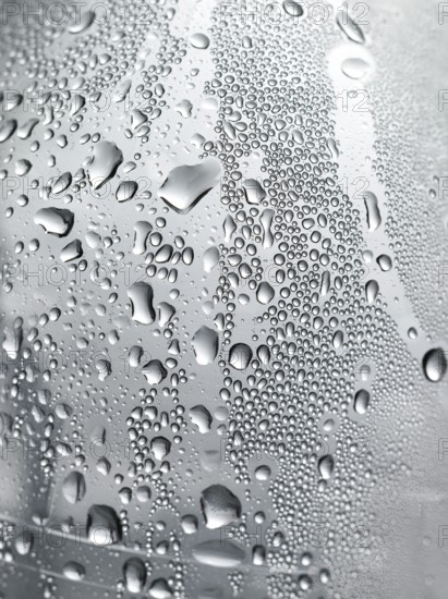 Drops of water on plastic bottle, neutrally illuminated, detailed view