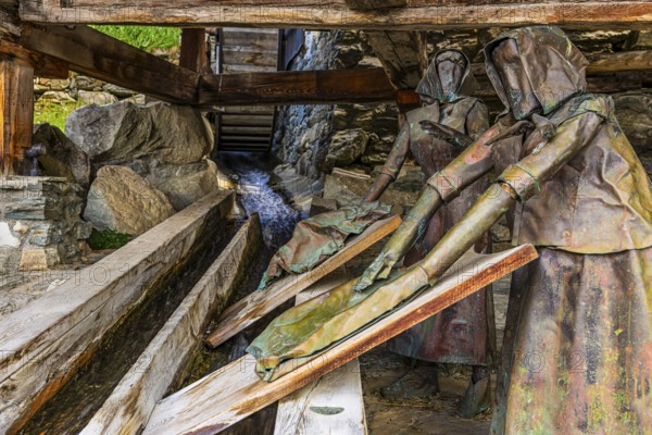 Copper sculptures of two washerwomen at the historic washing place, Saint Luc, Val d'Anniviers, Valais Alps, Canton Valais, Switzerland