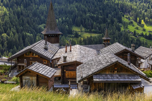 Houses with wooden shingle roofs, behind the church of Saint Anna, Ayer, Val d'Anniviers, Valais Alps, Canton Valais, Switzerland