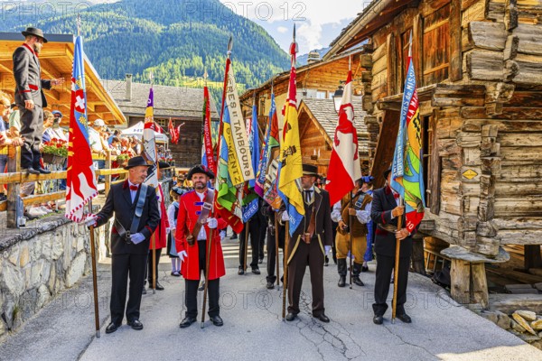 Drummers' and pipers' meeting in Mission, here the flag bearers of various music groups, Val d'Anniviers, Valais Alps, Canton Valais, Switzerland