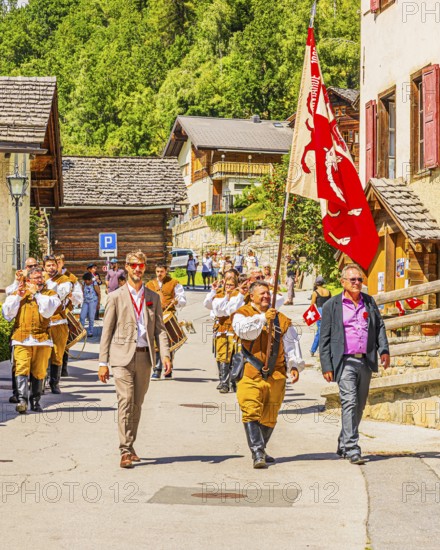 Drummers' and pipers' meeting in Mission, here the entry of a music group led by a standard-bearer, Val d'Anniviers, Valais Alps, Canton Valais, Switzerland