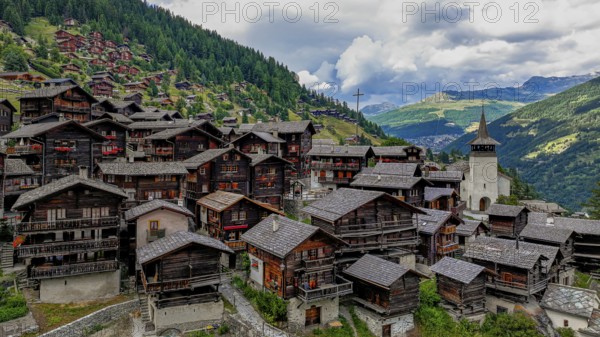 The historic centre of Grimentz with the church of Saint Theodule, drone image, Val d'Anniviers, Valais Alps, Canton Valais, Switzerland