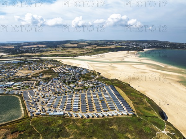 Holiday homes over Hayle Beach and Hayle Estuary from drone, St Ives Bay, Cornwall, England, United Kingdom