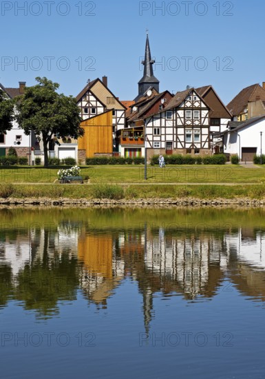 View over the river Weser to the old town centre of Bodenwerder with the church tower of St. Nicolai, Weserbergland, Lower Saxony, Germany