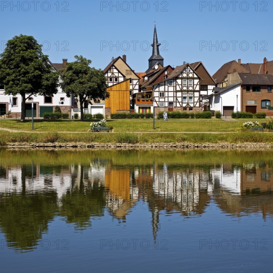 View over the river Weser to the old town centre of Bodenwerder with the church tower of St. Nicolai, Weserbergland, Lower Saxony, Germany
