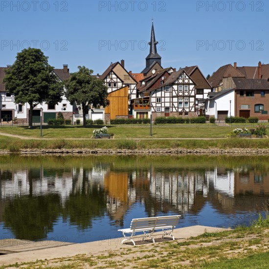 View over the river Weser to the old town centre of Bodenwerder with the church tower of St. Nicolai, Weserbergland, Lower Saxony, Germany
