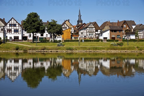 View over the river Weser to the old town centre of Bodenwerder with the church tower of St. Nicolai, Weserbergland, Lower Saxony, Germany