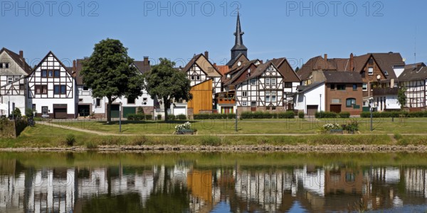 View over the river Weser to the old town centre of Bodenwerder with the church tower of St. Nicolai, Weserbergland, Lower Saxony, Germany