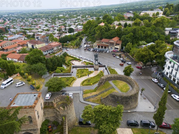 Bird's eye view of castle-like structures with monument and trees in urban surroundings, aerial view, equestrian monument to King Irakli II and Batonis Ziche, Batonistsikhe, royal fortress, Telavi, Telavi, Kakheti region, Georgia