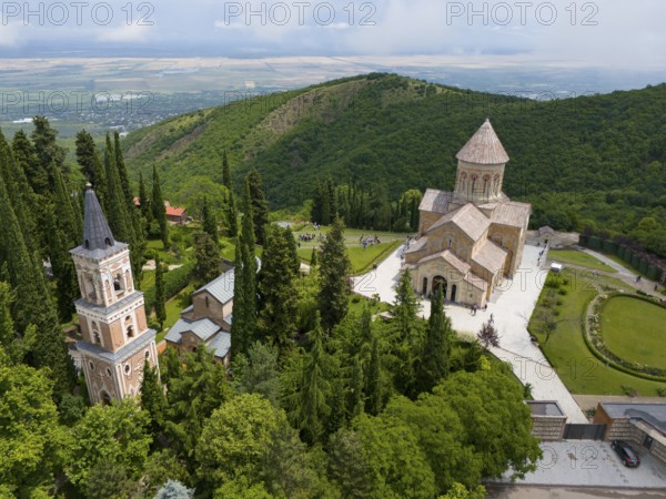 Historic monastery on a green hill surrounded by trees and towers, Bodbe Monastery, Sighnaghi, Signagi, Kakheti Province, Greater Caucasus, Georgia, Near East