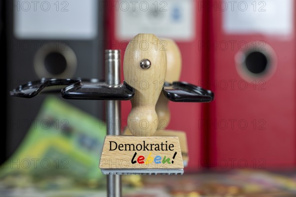 (Photomontage) Close-up of a stamp with the DEMOKRATIE LEBEN lettering