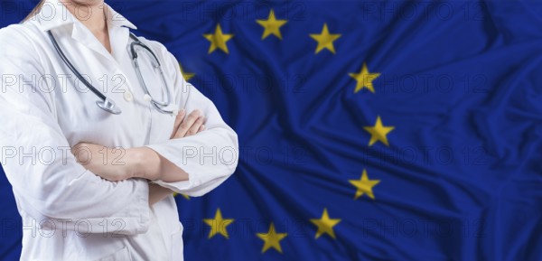 Doctor with crossed arms on European Union flag. European Union health and care concept. Female doctor on European Union flag