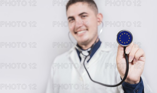 Doctor showing stethoscope with European Union flag. European Union national healthcare concept